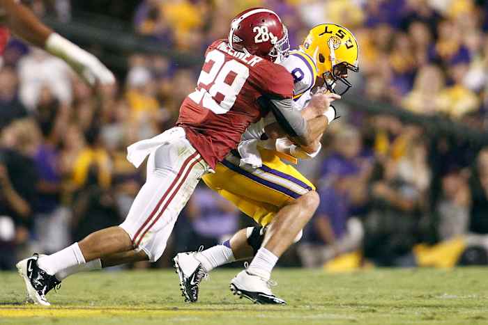 LSU Tigers quarterback Zach Mettenberger (8) is sacked by Alabama Crimson Tide defensive back Dee Milliner (28) during the first half at Tiger Stadium.